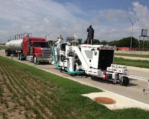 A large truck is pulling a trailer down the road.