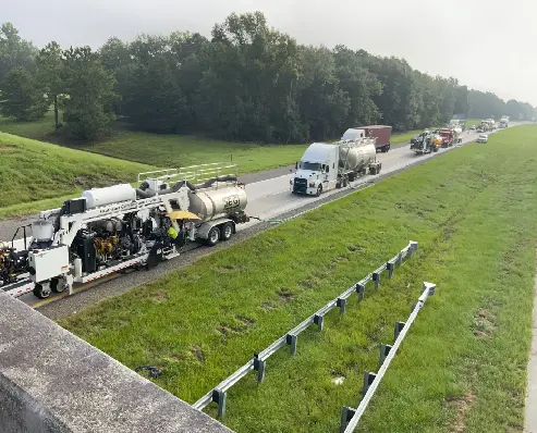 A group of trucks on the side of a road.