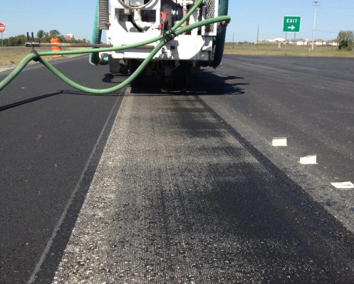 A truck with a hose attached to it's back.