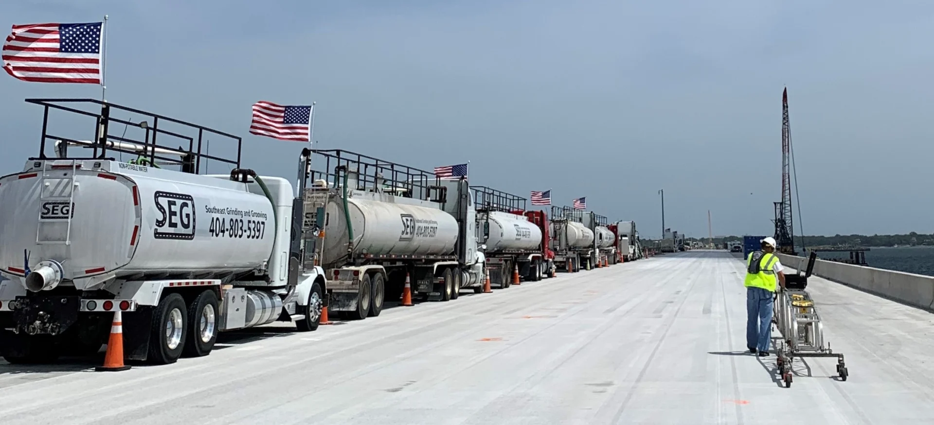 A line of trucks parked on the side of a road.